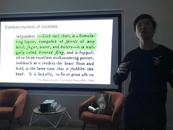 Leon presenting a slide about the history of cocktails.