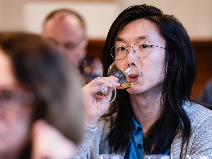 Leon tasting wine from a glass.